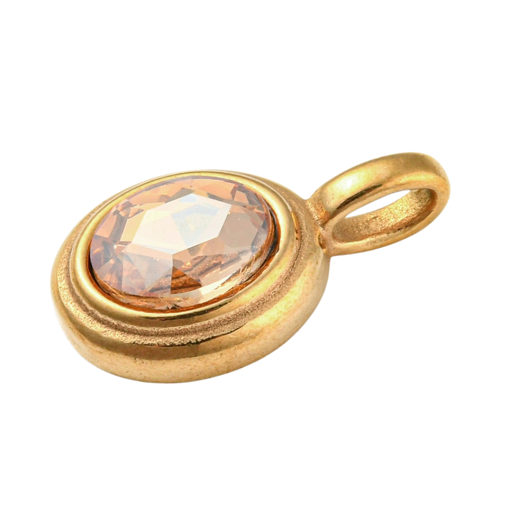 Side of the Gold Oval Framed Topaz Glass Stone Charm on a White background
