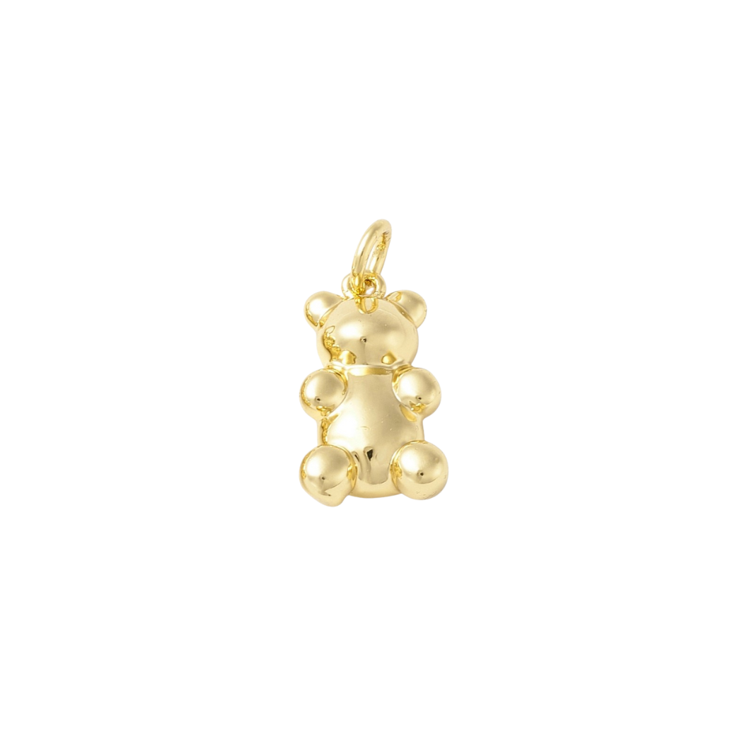 Gold teddy bear pendant on a white background