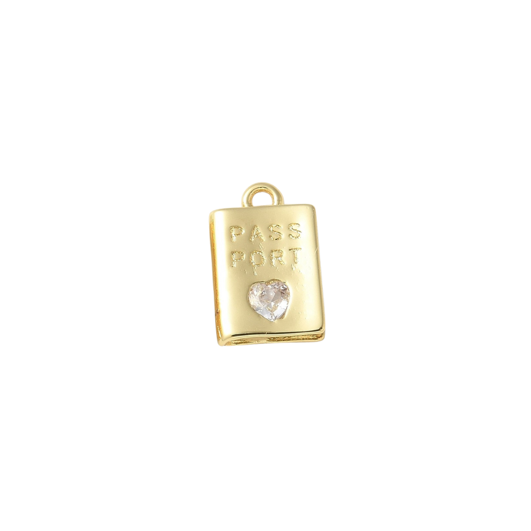Gold charm shaped like a passport with a heart on a white background