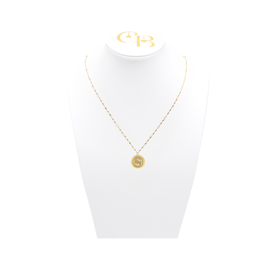 High Point University gold twist necklace with small round charm with high point university text and hpu logo on white pillow front view
