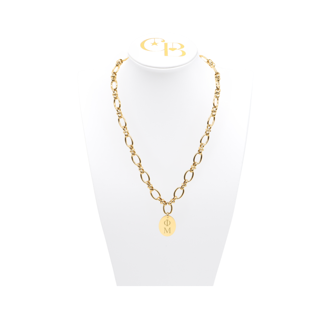 Phi Mu gold large link evermore necklace with large oval charm with vertical greek letters on white necklace bust front