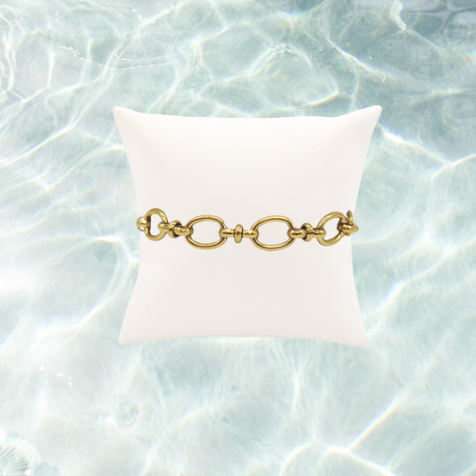 Gold Evermore Bracelet on water background 