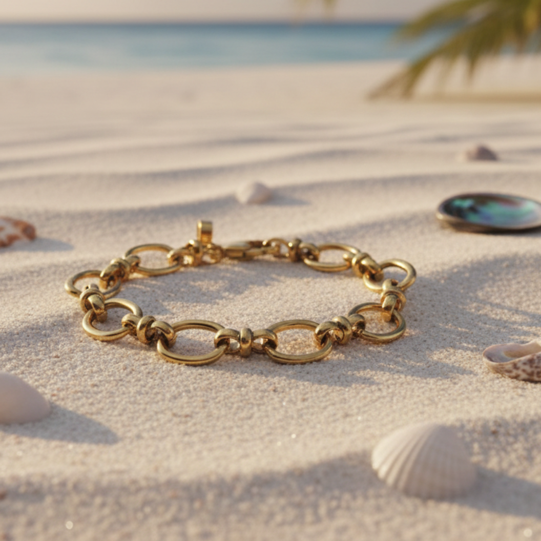 Gold Evermore Bracelet laying on the sand