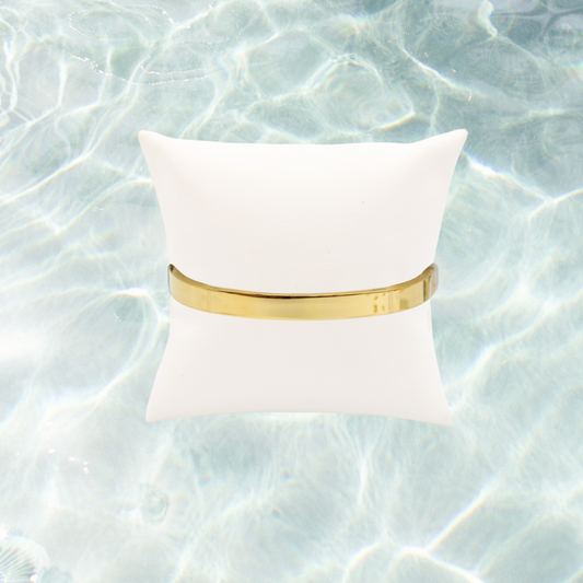 Gold Plain Bangle Bracelet | Waterproof, Hypoallergenic & Tarnish Resistant on water background 