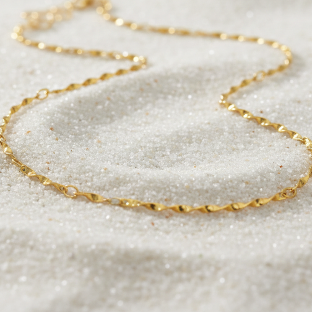 Gold Simple Twist Necklace | Waterproof, Hypoallergenic & Tarnish Resistant on sand as background 