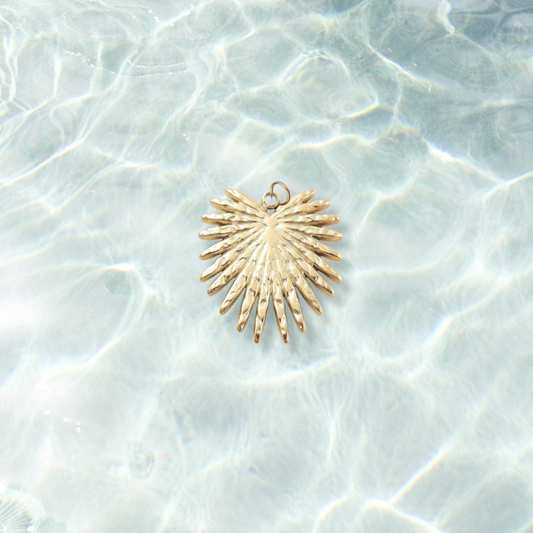 Gold Leaf Burst Charm | Waterproof Stainless Steel on water background