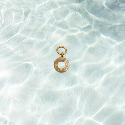 Gold Roman Radiance Ring with Cubic Zirconia Charm | Waterproof Stainless Steel on water background