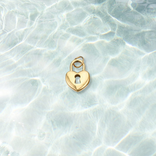 Gold Locked in Love Charm | Waterproof Stainless Steel on water background 
