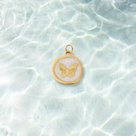 Gold Whimsical White Butterfly Charm | Waterproof Stainless Steel on water background 