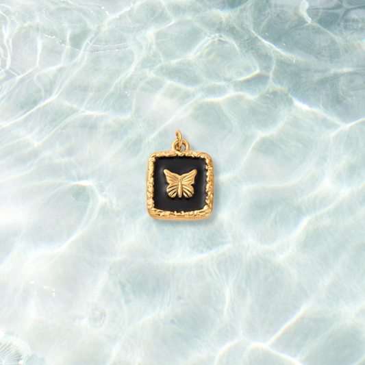 Gold Midnight Framed Butterfly Charm | Waterproof Stainless Steel on water background 
