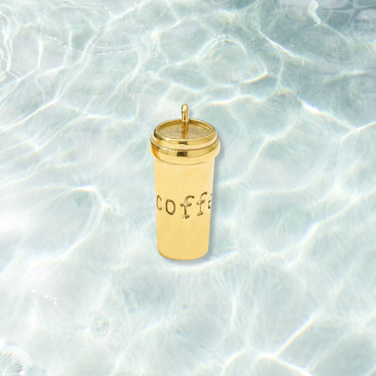 Gold Coffee To Go Charm on water background 