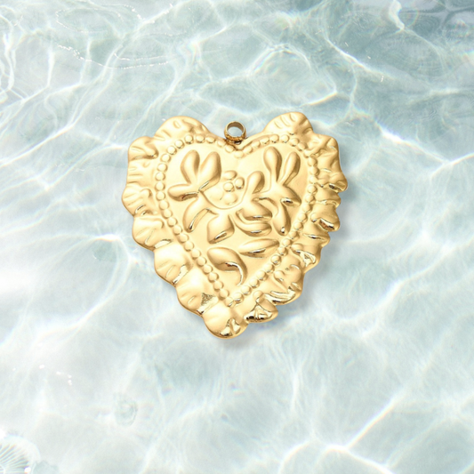 Gold Scalloped Flora Heart Charm on water background 