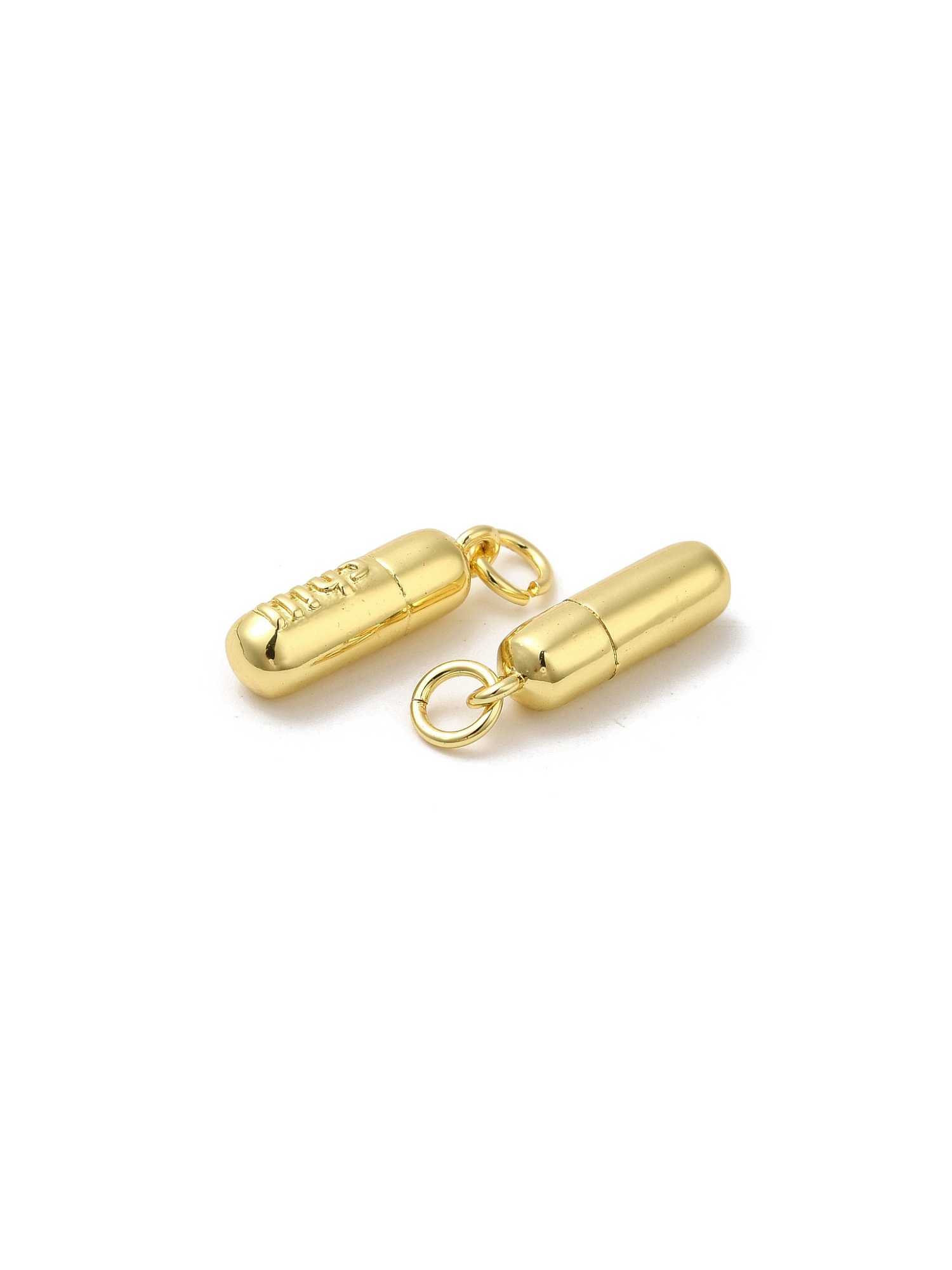 Two Chill Pill Charms on white background sideways.