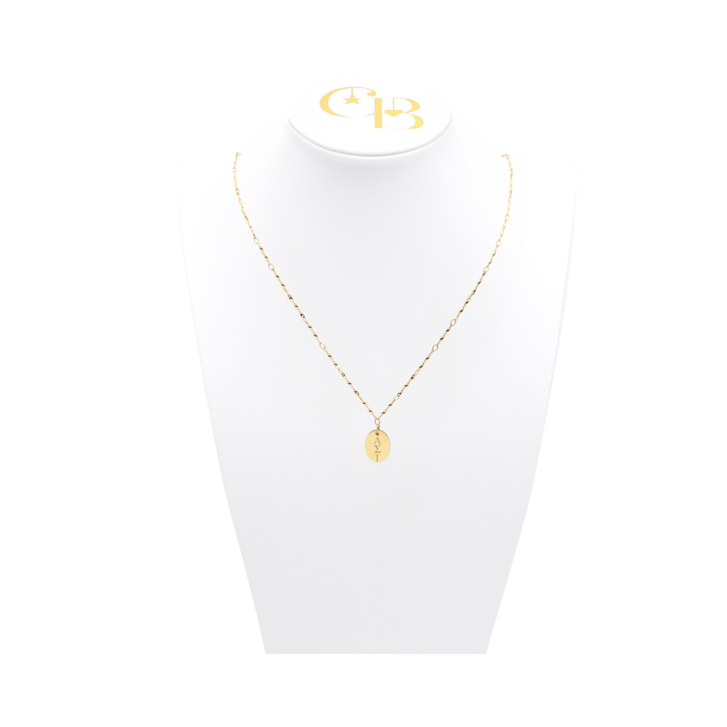 Alpha Sigma Tau gold simple twist necklace with small gold oval charm displayed on white necklace bust front view with vertical/stacked greek letters.