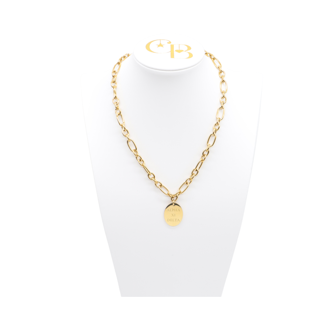 Alpha XI Delta gold large link keepsake necklace with large oval charm displayed on white necklace bust front view with full sorority name