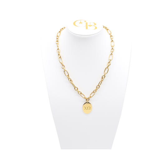 Chi Omega gold large link Keepsake Necklace with large oval charm with horizontal greek letters on white bust front view
