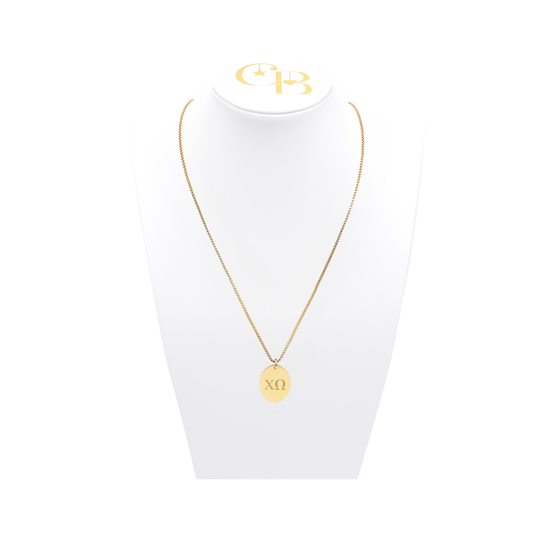 Chi Omega gold link storyline necklace with small oval charm with horizontal greek letters on white bust front view
