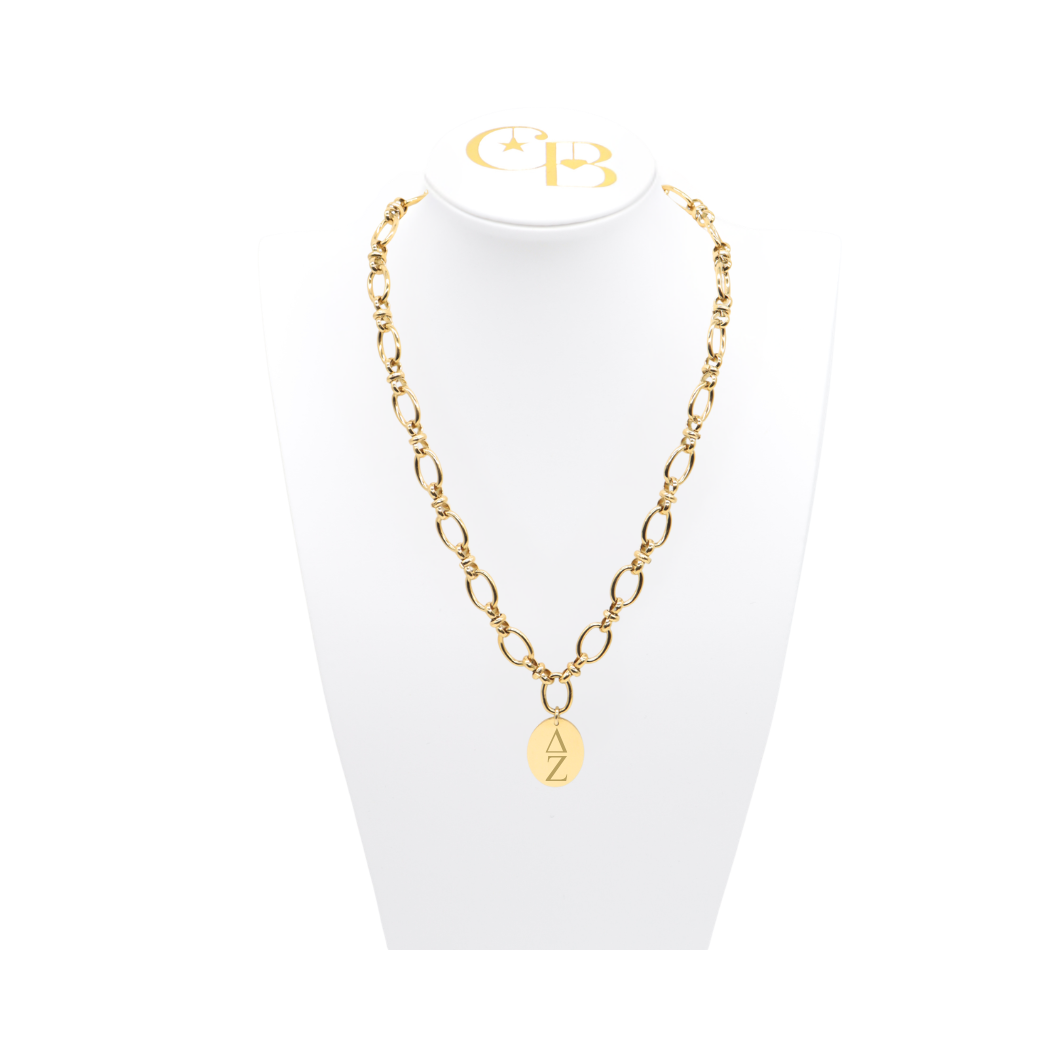 Delta Zeta gold large link Keepsake Necklace with large oval charm with vertical greek letters on white bust front view