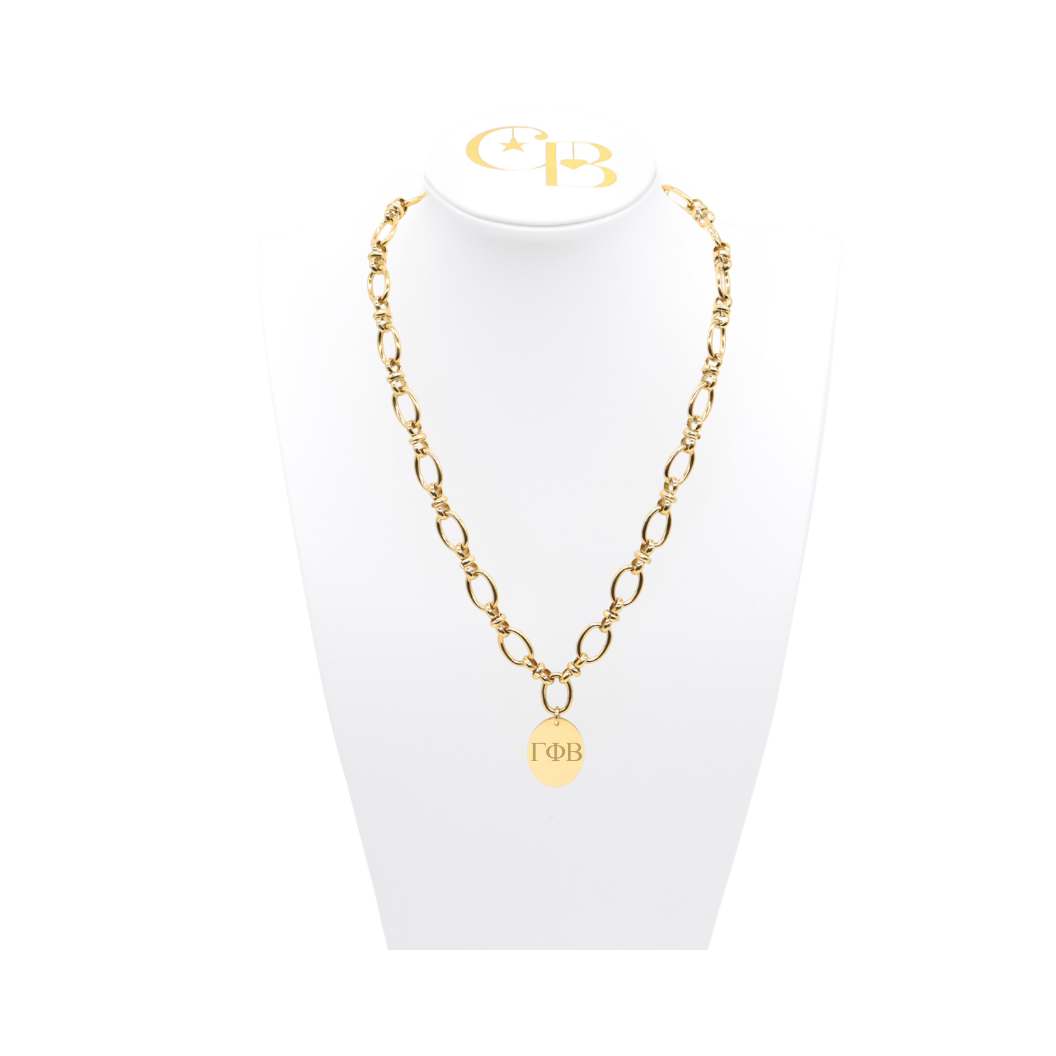 Gamma Phi Beta gold large link evermore necklace with large oval charm displayed on white necklace bust front view with vertical/stacked greek letters