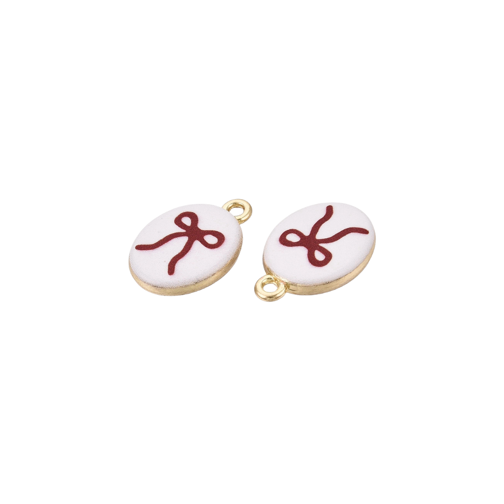 Side view of a pair of gold oval charms featuring a red bow illustration on a white background