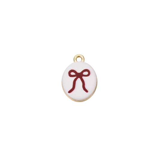 Gold oval charm featuring a red bow illustration on a white background