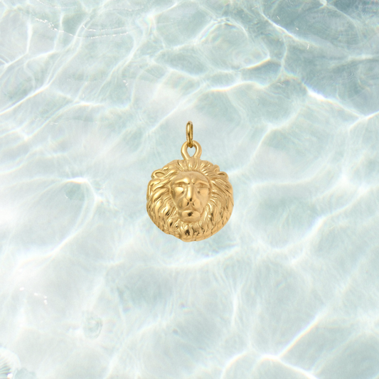 Gold Royal Lion Charm featuring a detailed lion head design with a textured mane on a shimmering water background.