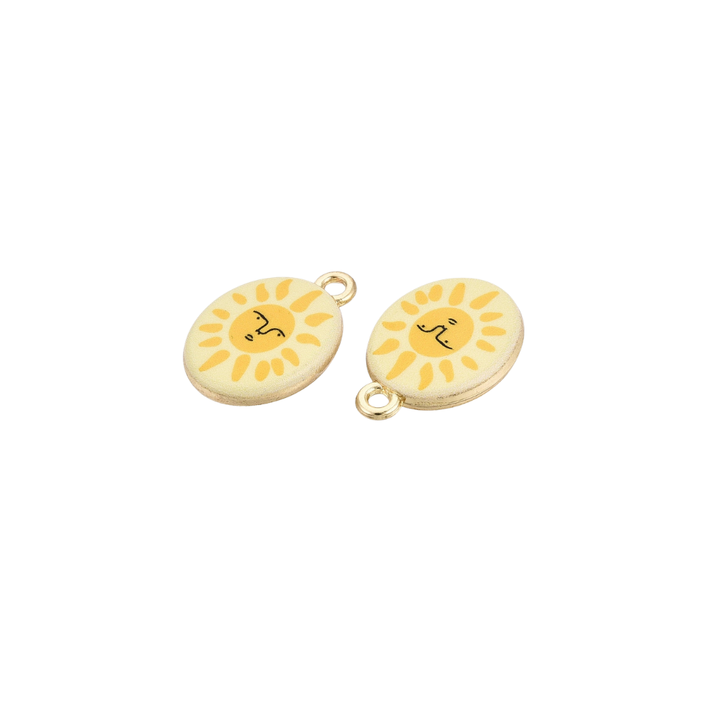 Two gold oval charms featuring smiling sun face illustrations with yellow rays on a cream background