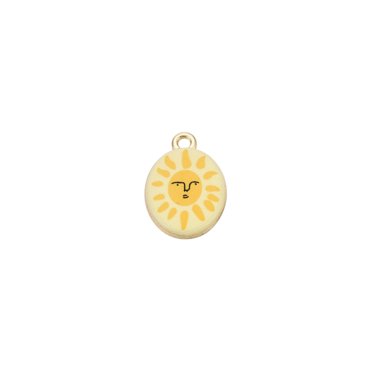 Gold oval charm featuring a smiling sun illustration with yellow rays on a cream background