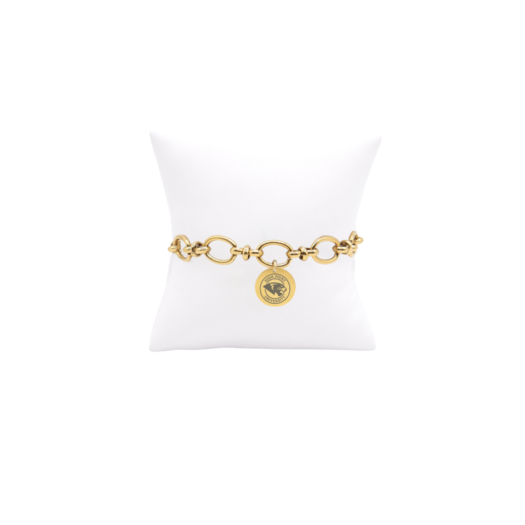 High Point University gold large link Evermore bracelet with large round charm with high point university text and panther logo on white pillow front view
