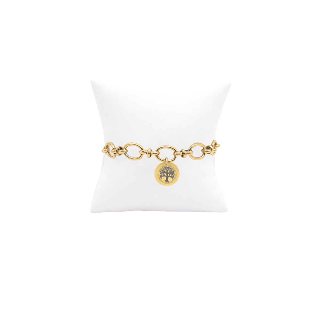 High Point University gold large link Evermore bracelet with small round charm with high point university life skills tree on white pillow front view
