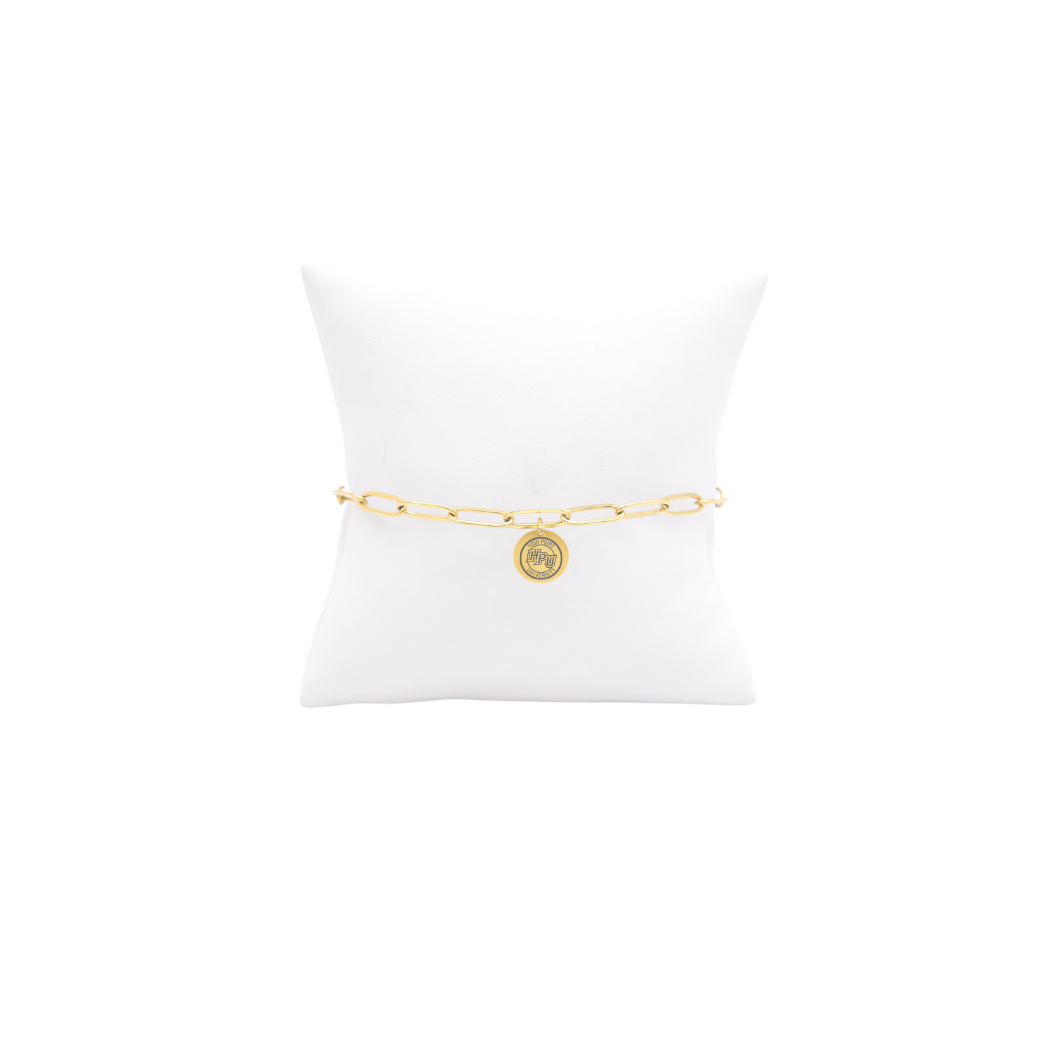 High Point University gold link storyline bracelet with small oval charm with high point university text and hpu logo on white pillow front view

