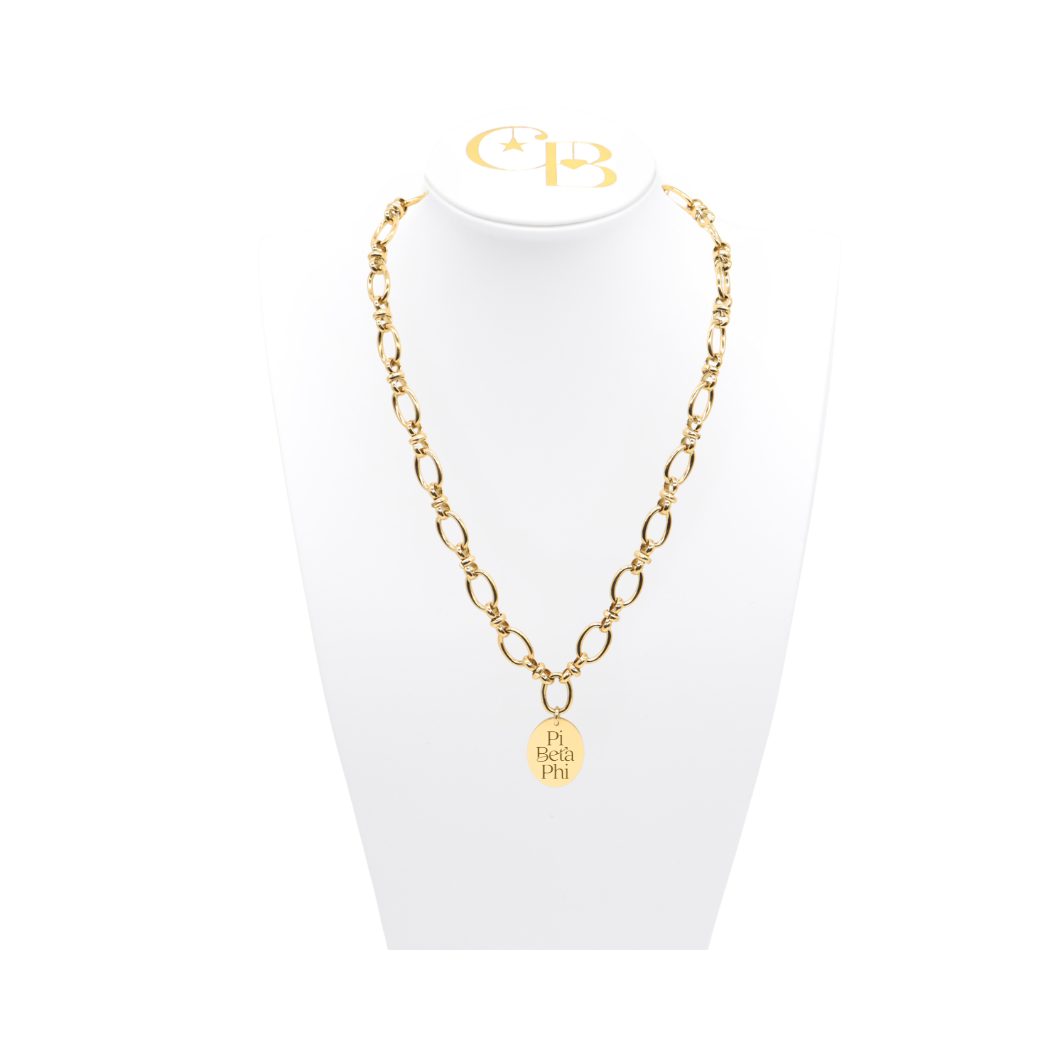 Pi Beta Phi gold large link evermore necklace with large oval charm displayed on white necklace bust front view with new stacked logo