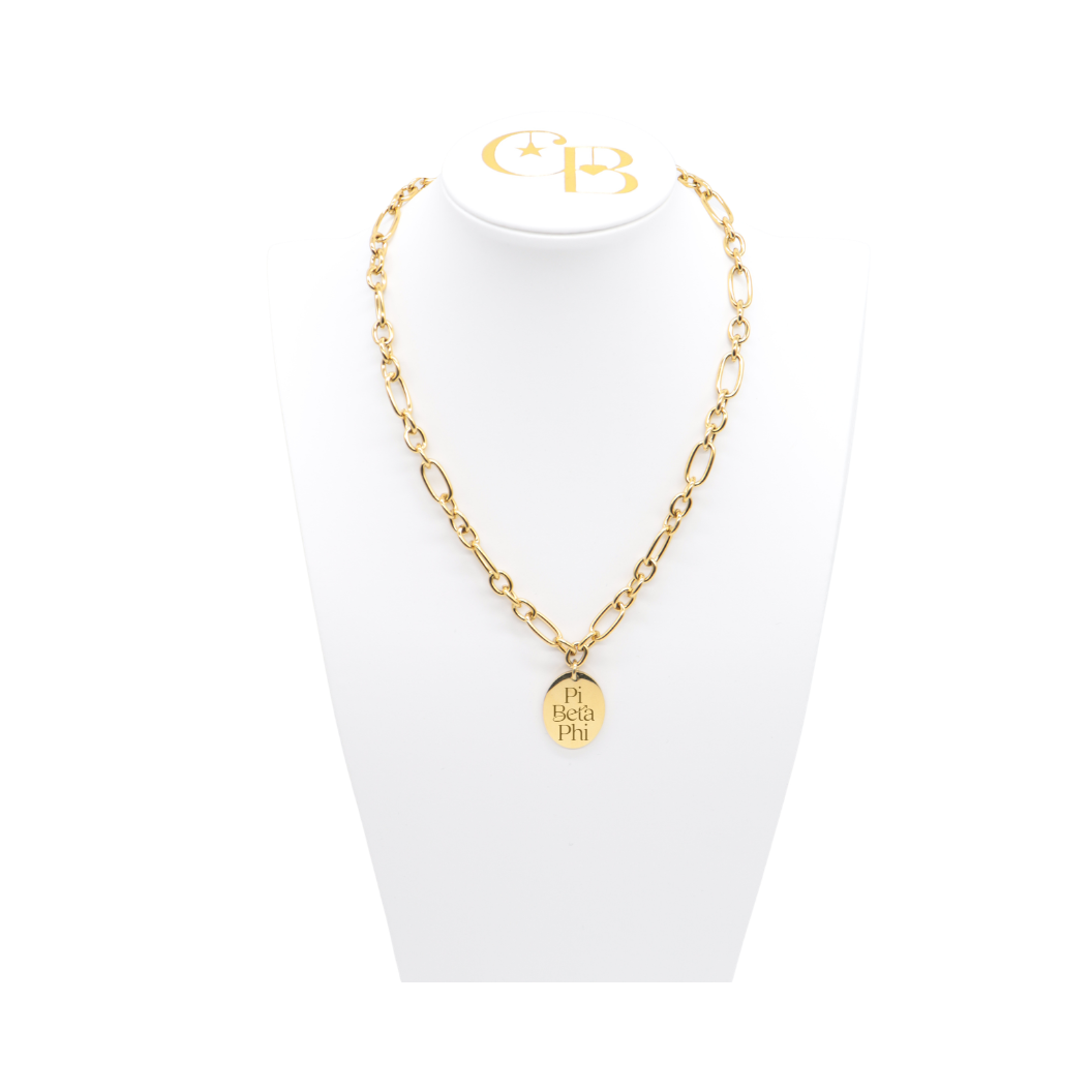 Pi Beta Phi gold large link keepsake necklace with large oval charm displayed on white necklace bust front view with new stacked logo