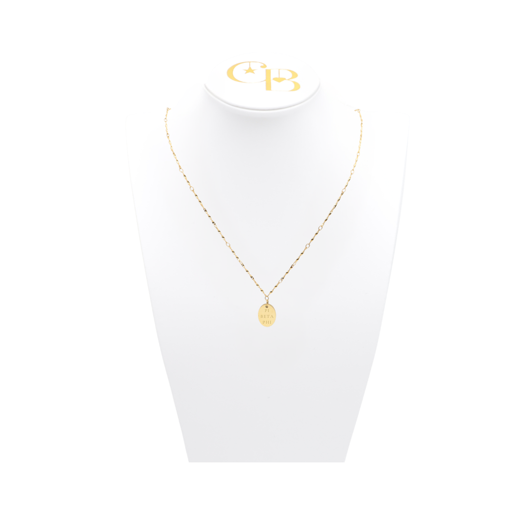 Pi Beta Phi gold simple twist necklace with small oval charm displayed on white necklace bust front view with full sorority name