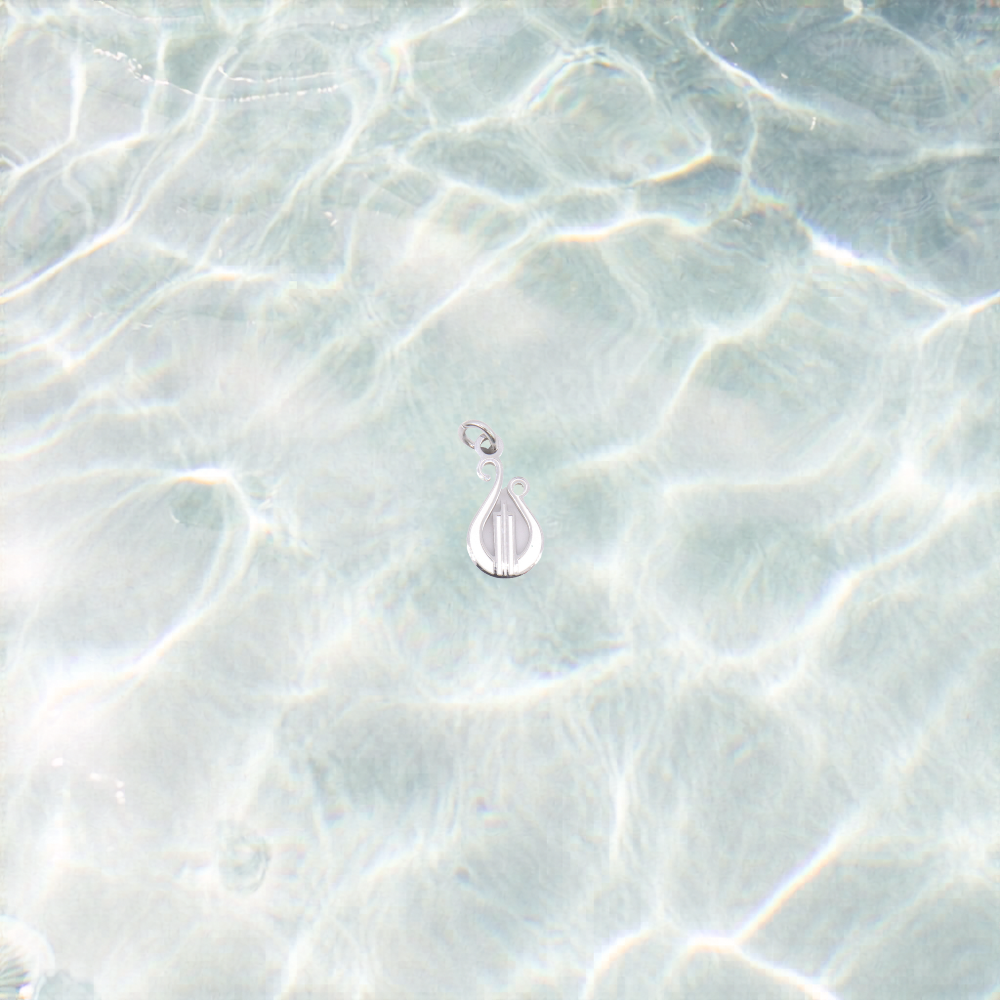 Silver lyre charm on a shimmer water background