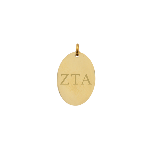 Zeta Tau Alpha gold large oval charm with horizontal greek letters front view.